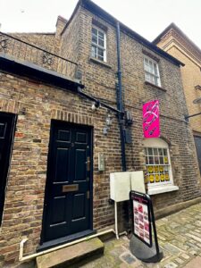 Photo of the front of the building with sign in pink with the say The Brazilian Beauty Spa